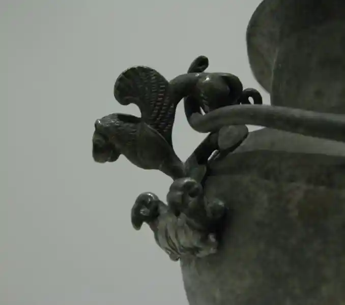 A winged lion on top of two rams A winged lion on top of two rams